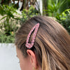 Pink crystal hair clip set on a well-made sturdy back.