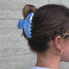 Girl wearing our go-to claw in blue