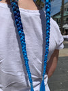 Girl wearing jumbo hair braid in green, navy and blue.
