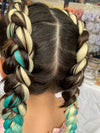 Girl wearing jumbo hair braid in blonde, green and blue.