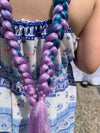 Girl wearing jumbo hair braid in dark purple, teal and lilac.