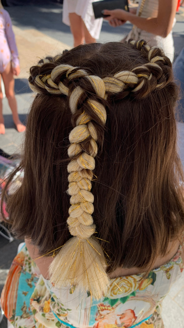 Girl wearing jumbo hair braid in gold blonde with gold tinsel. Measurements: Each strand is 48 inches long.