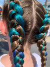 Girl wearing jumbo hair braid in green, navy and blue.