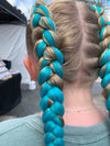 Girl wearing jumbo hair braid in teal.