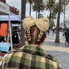 Girl wearing jumbo hair braid in gold blonde with gold tinsel.