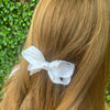 Girl wearing white Diamonte Hair Bow.