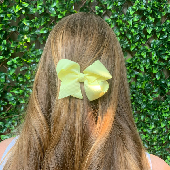 Girl wearing lemon bow. Size: 100mm x 80mm (approx 3 1/2 inches).
