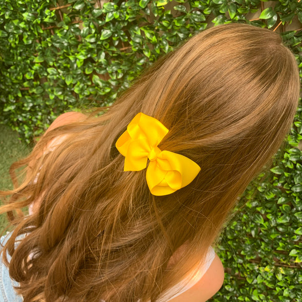 Girl wearing yellow hair bow.