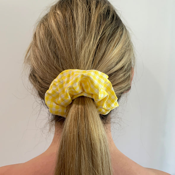 Blonde lady wearing Yellow - Picnic 4 2 Scrunchie. Colour/Pattern: Yellow and white gingham.  Material: Cotton. Dimensions: Material width approximately 4cm.  Made by us in Bondi Beach.