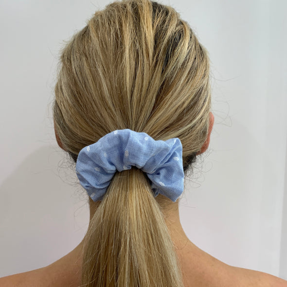 Blonde lady wearing Blue - Dani Scrunche. Colour/Pattern: Blue with small white embroidered diamond shapes Material: Cotton. Dimensions: Material width approximately 4cm Made by us in Bondi Beach.