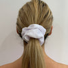 Girl wearing White - Evie Scrunchie. Colour/Pattern: White Material: Velveteen. Dimensions: Material width approximately 4cm Made by us in Bondi Beach.