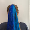 Girl wearing aqua blue hair tinsel - 48 inches long and comes in a pack of 120 strands.
