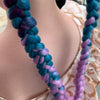 Girl wearing jumbo hair braid in lilac, teal & dark purple. Measurements: Each strand is 48 inches long.