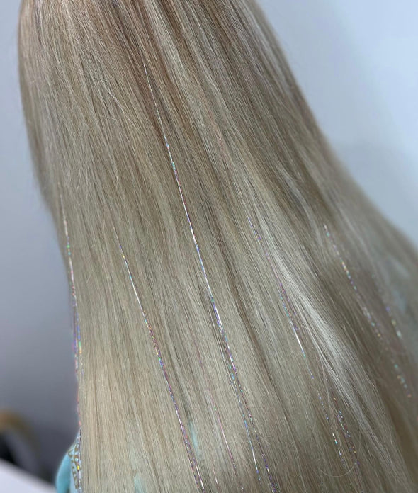 Girl wearing silver tinsel - 48 inches long and comes in a pack of 120 strands.