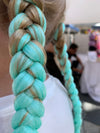 Girl wearing jumbo hair braid - Glow in the dark - spearmint. Each strand is 48 inches long. As a braid it is 24 inches long.