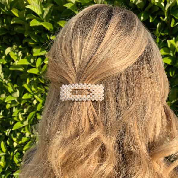 Small rectangle shaped hair clip with gold coloured base.