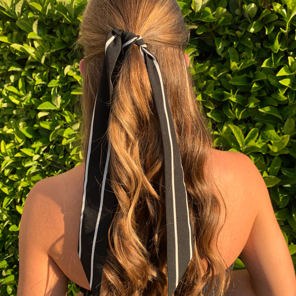 Girl wearing gorgeous black with white stripe hair scarf.