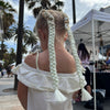 Girl wearing jumbo hair braid in white.