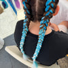 Girl wearing jumbo hair braid in blue, light blue, spearmint and white.