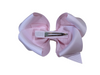 Pale pink bow made with grosgrain material.