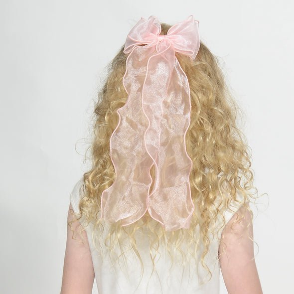 Girl wearing pink long hairbow.