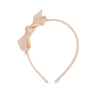 Pale apricot headband with bow.