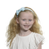 Girl wearing pale blue headband with bow.
