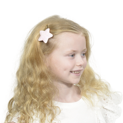 Girl wearing star hair clip in pink colour (one star on clip)