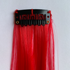 Clip in red hair extension. Measurements: 50cm x 3.5cm. Soft synthetic fibre hair.